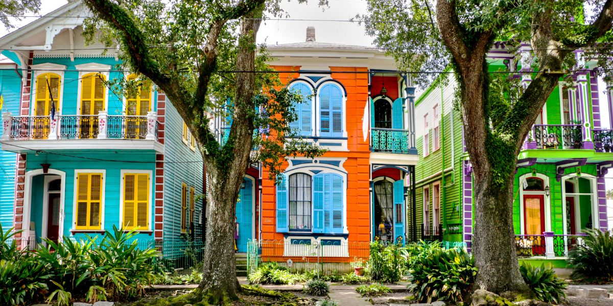 Vibrant New Orleans-style homes with decorative shutters and balconies.
