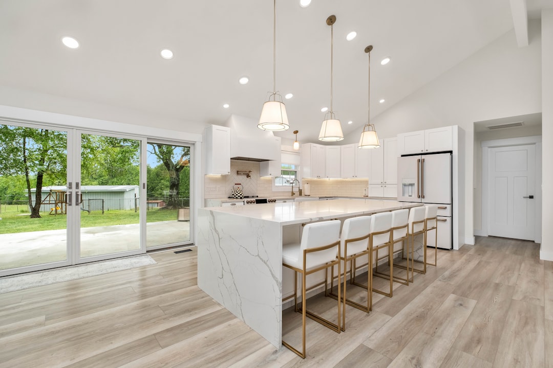 Bright and modern newly renovated kitchen with neutral-colored cabinets, quartz countertops, and stainless steel appliance...